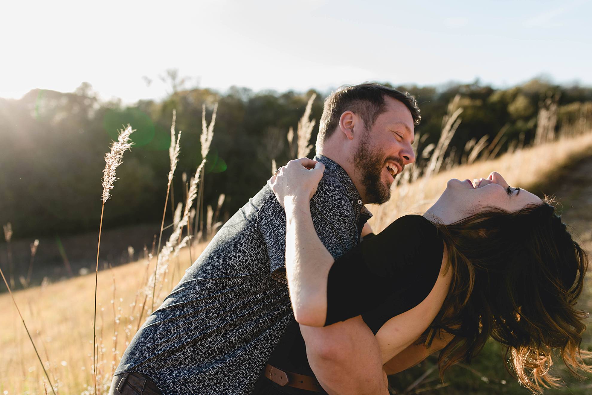 engaged couple laughing together at omaha engagement session