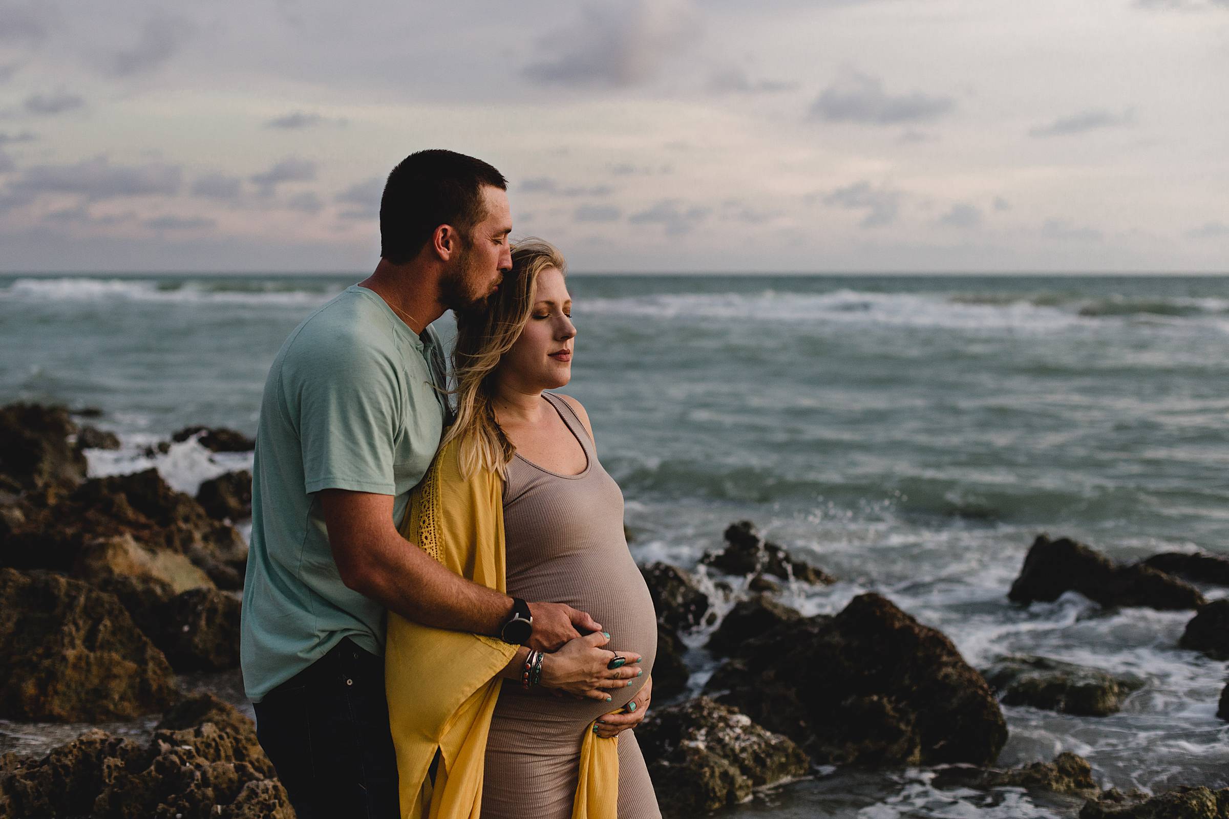 Maternity session with couple on beach with rocks,Maternity session in venice fl, caspersen beach maternity session, photographer in sarasota fl, juiana montane photography