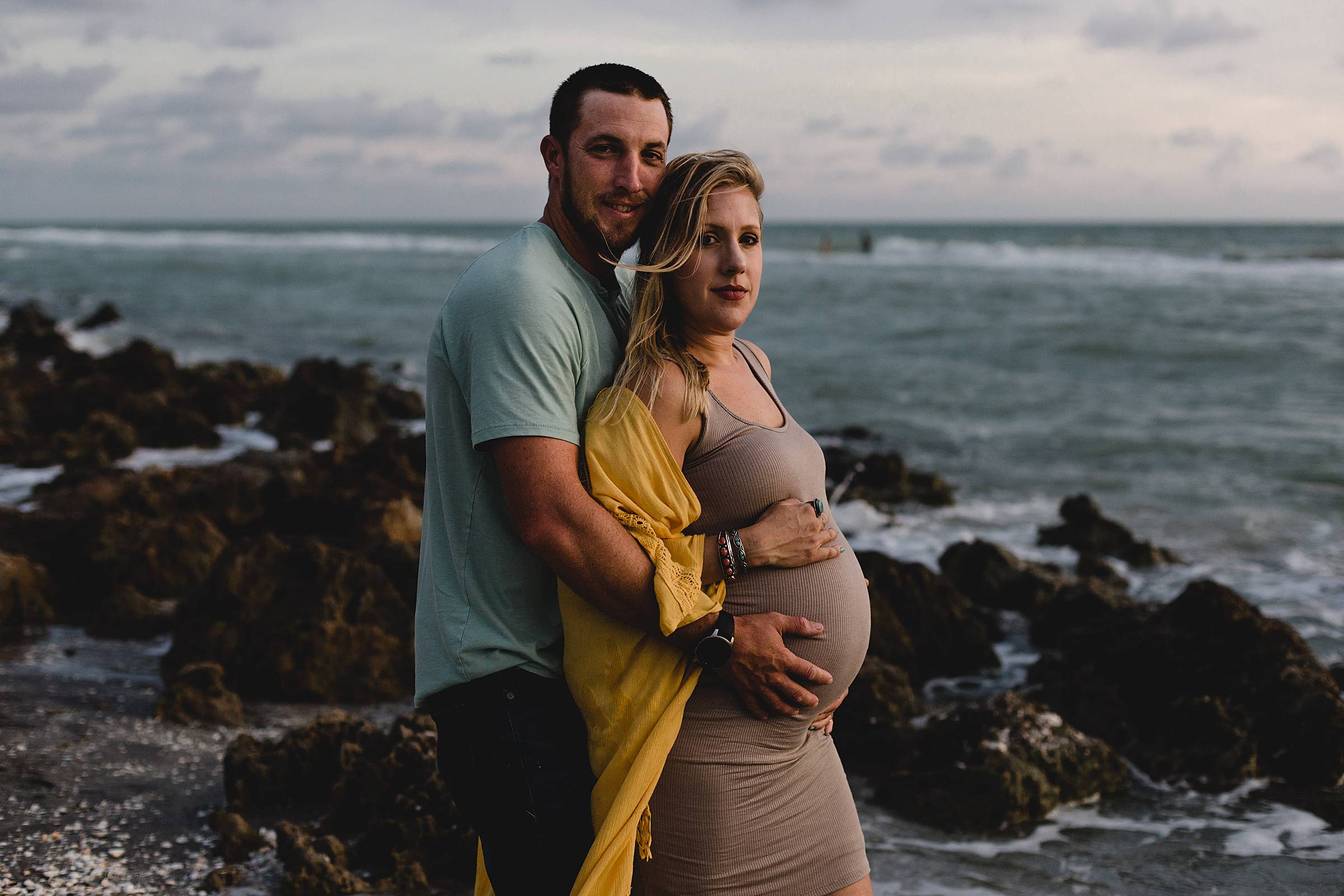 Maternity session with couple on beach with rocks,Maternity session in venice fl, caspersen beach maternity session, photographer in sarasota fl, juiana montane photography