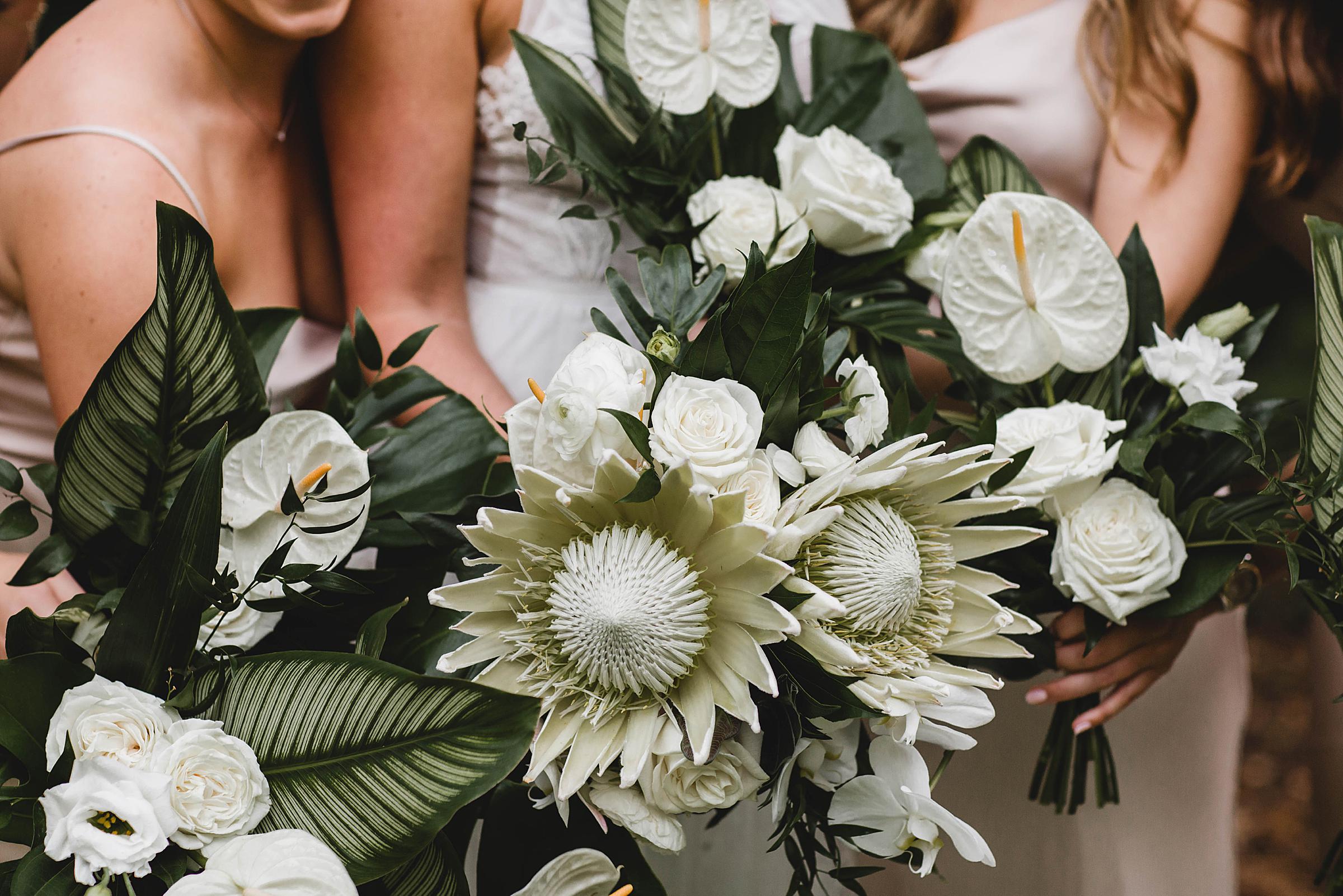 bride and bridesmaids bouquets close up at selby gardens wedding