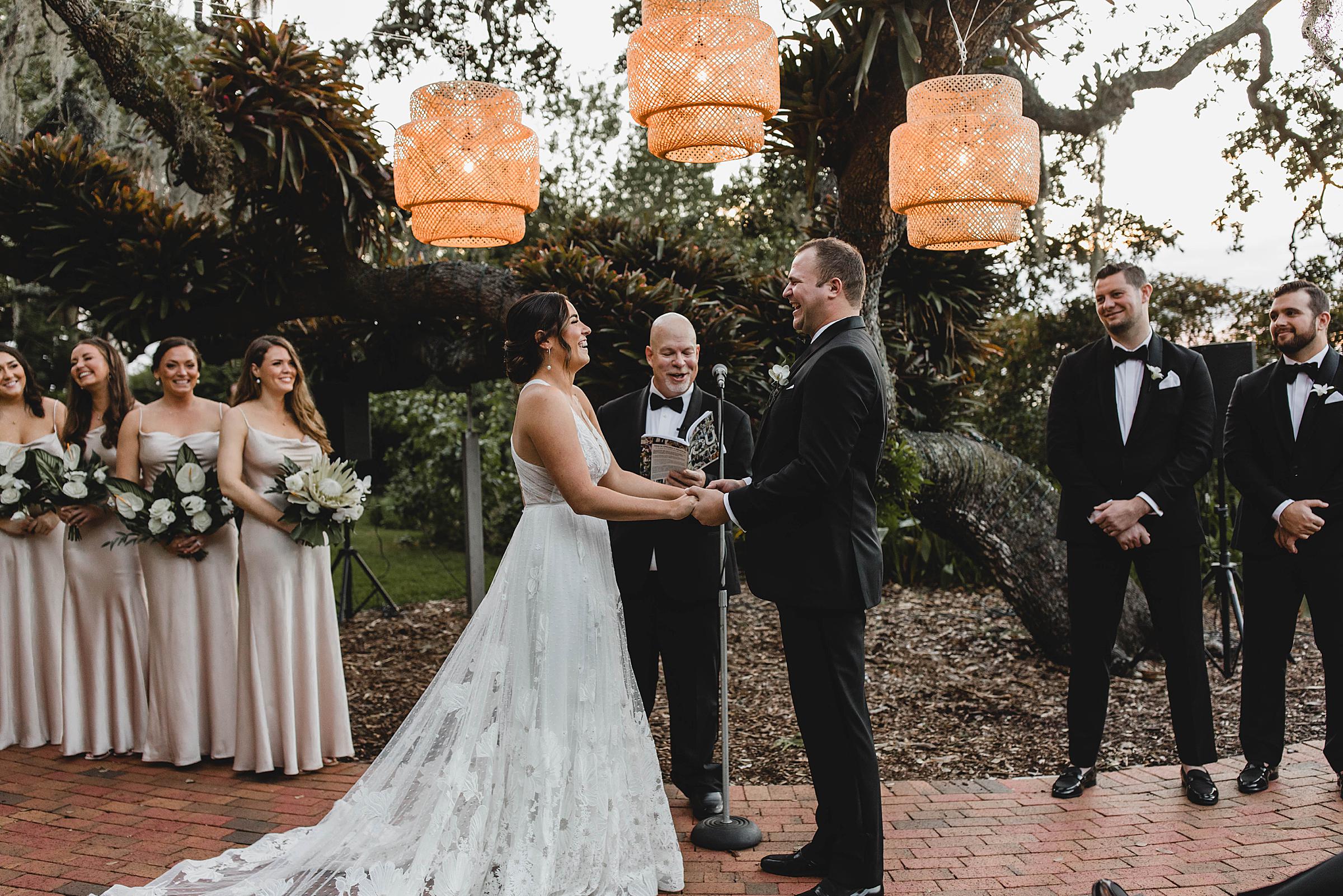 Marie Selby Botanical Gardens wedding, couple laughing during ceremony in front of large oak tree
