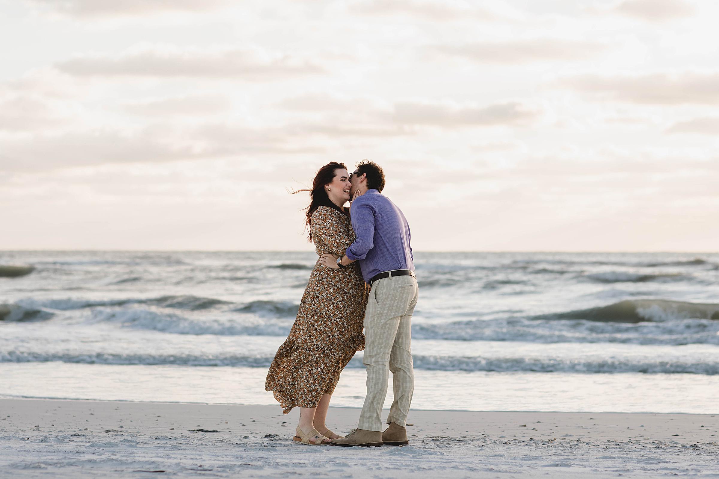 surprise proposal at Lido Beach, couple kissing after proposal in Sarasota Florida, juliana montane photography, sarasota proposal photographer