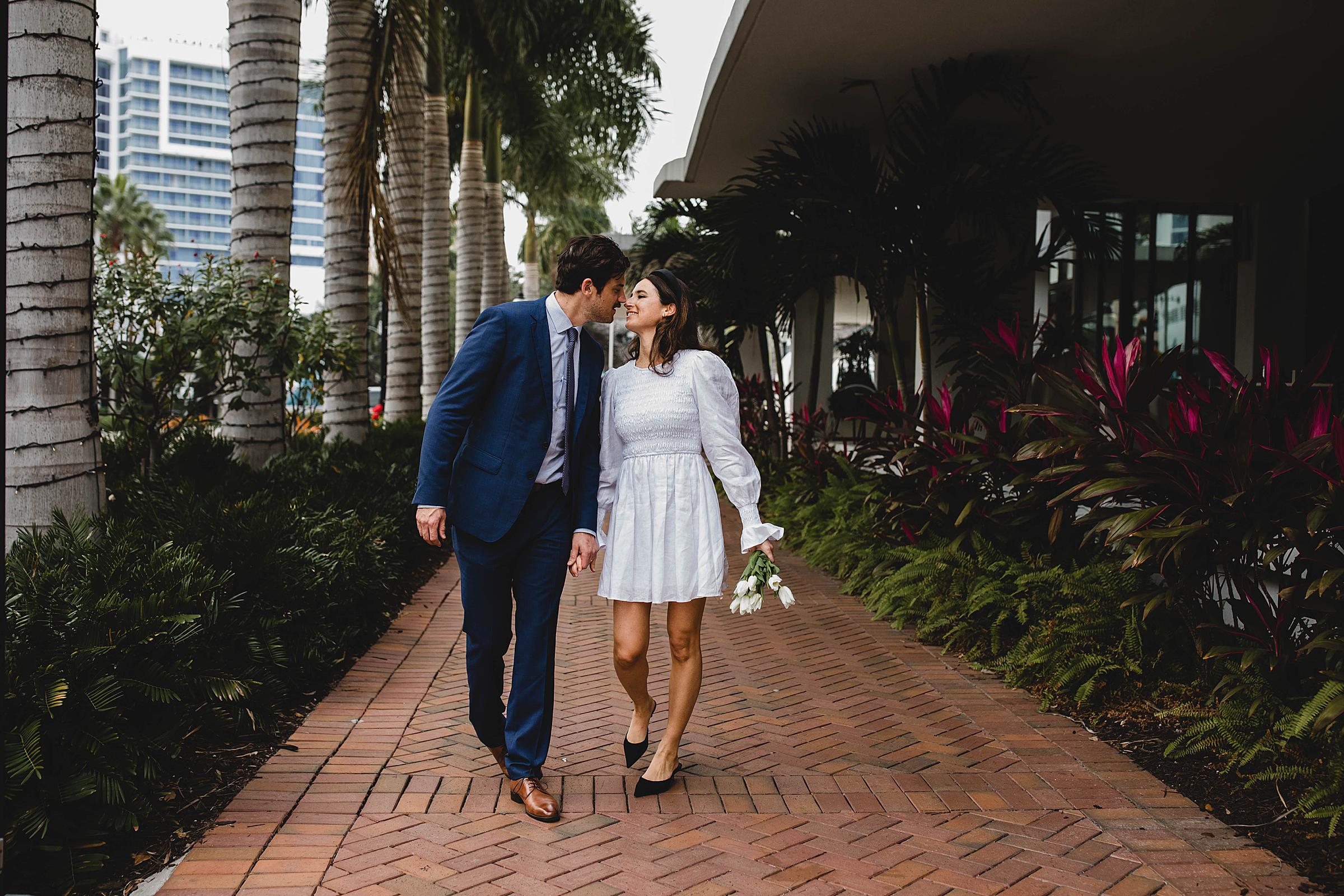 Newlyweds walking in downtown sarasota after sarasota courthouse wedding