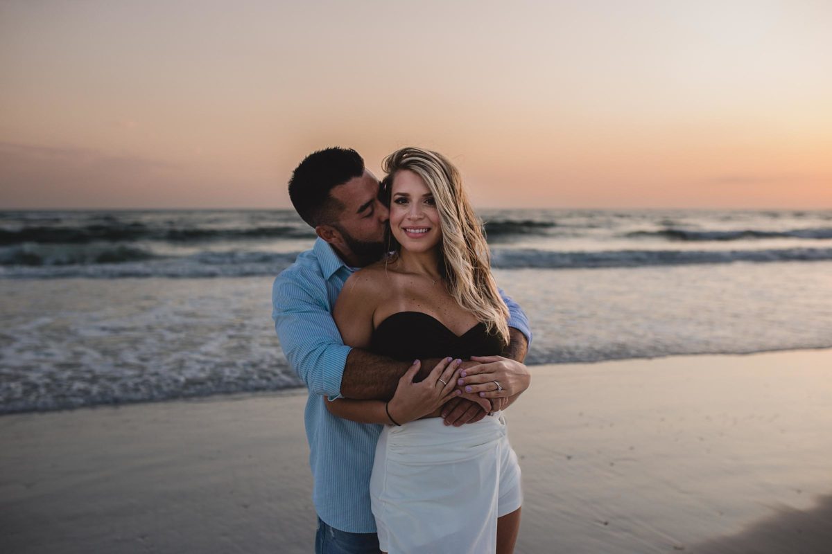couple just engaged on lido beach florida photographed by juliana montane photography