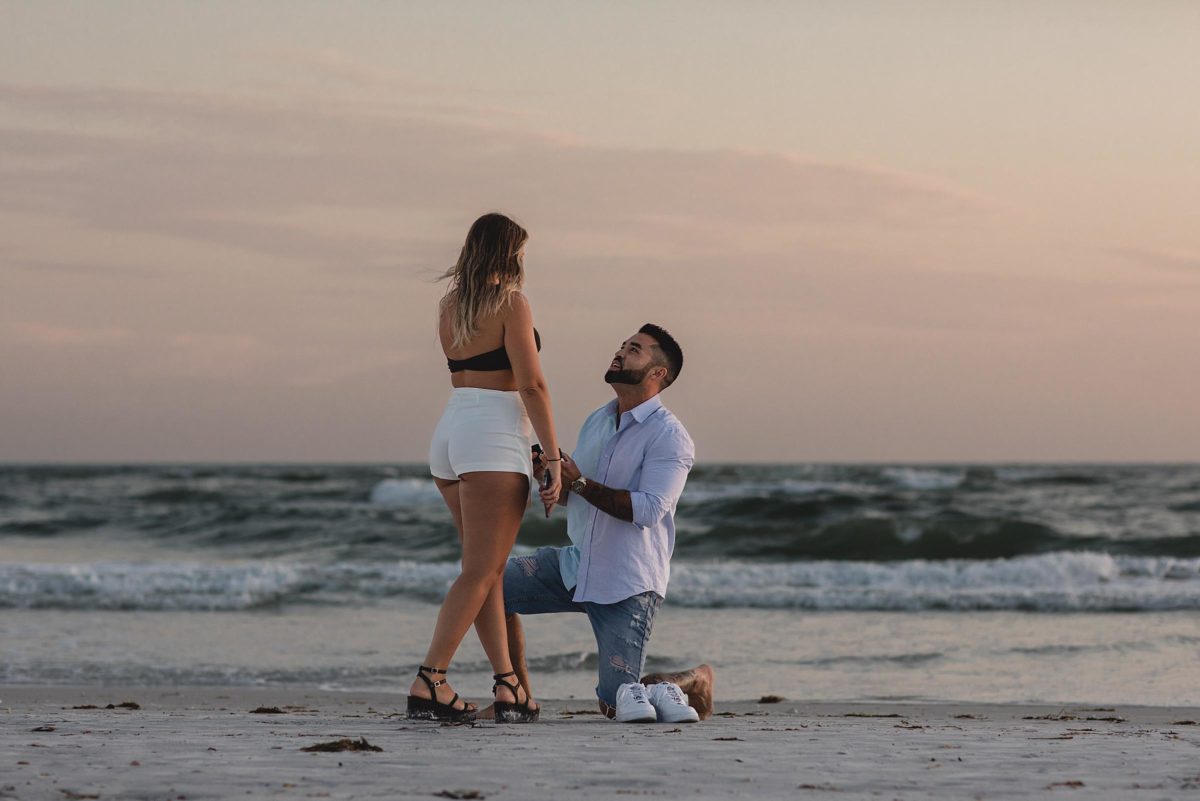 lido beach proposal, guy proposing to girl on the beach on lido key florida photographed by juliana montane photography