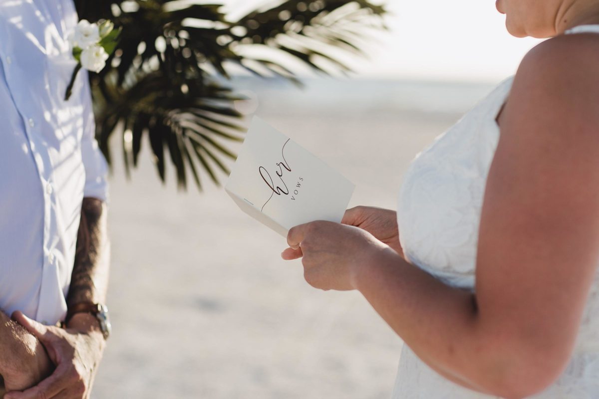 bride and groom reading their vows for clearwater beach elopement photographed by juliana montane photography