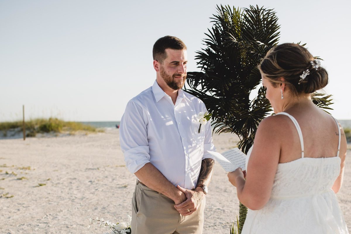 bride and groom reading their vows for clearwater beach elopement photographed by juliana montane photography