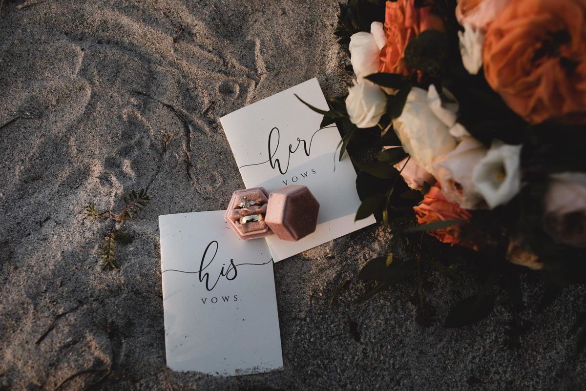 his and her vow notebooks with wedding rings and wedding bouquet at clearwater beach elopement in florida, juliana montane photography