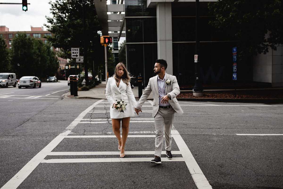 bride & groom walking down the street at downtown atlanta elopement photographed by juliana montane photograhy