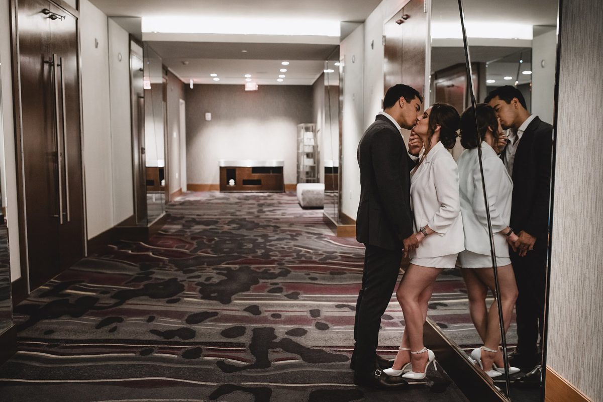 couple kissing in the art ovation hotel, sarasota engagement photo session photographed by juliana montane photography