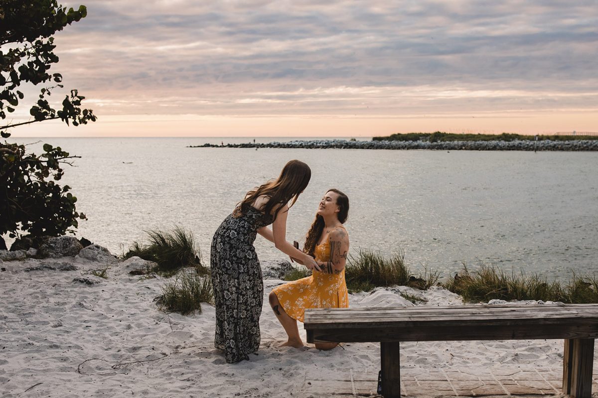 Woman proposing to her girlfriend on St pete beach in florida, photographed by Juliana Montane Photography
