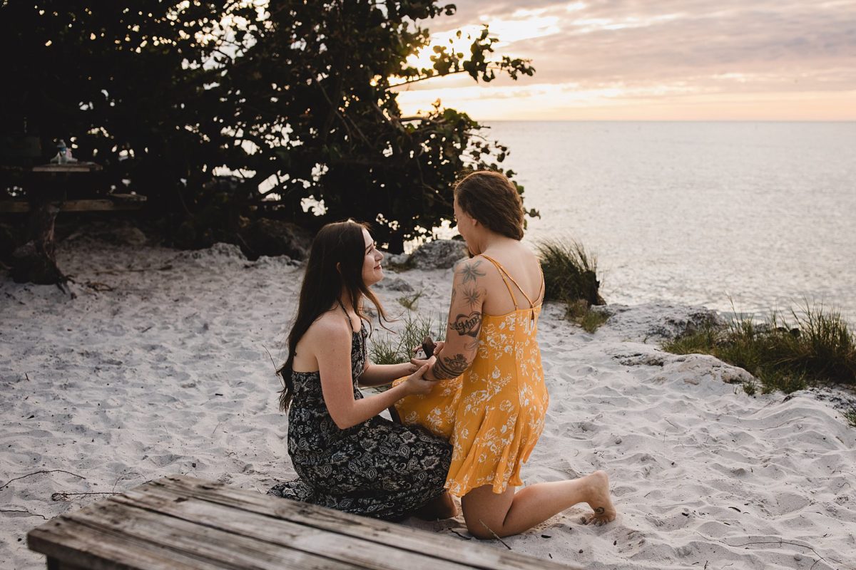 Woman proposing to her girlfriend on a beach in St. Pete, Florida photographed by Juliana Montane Photography