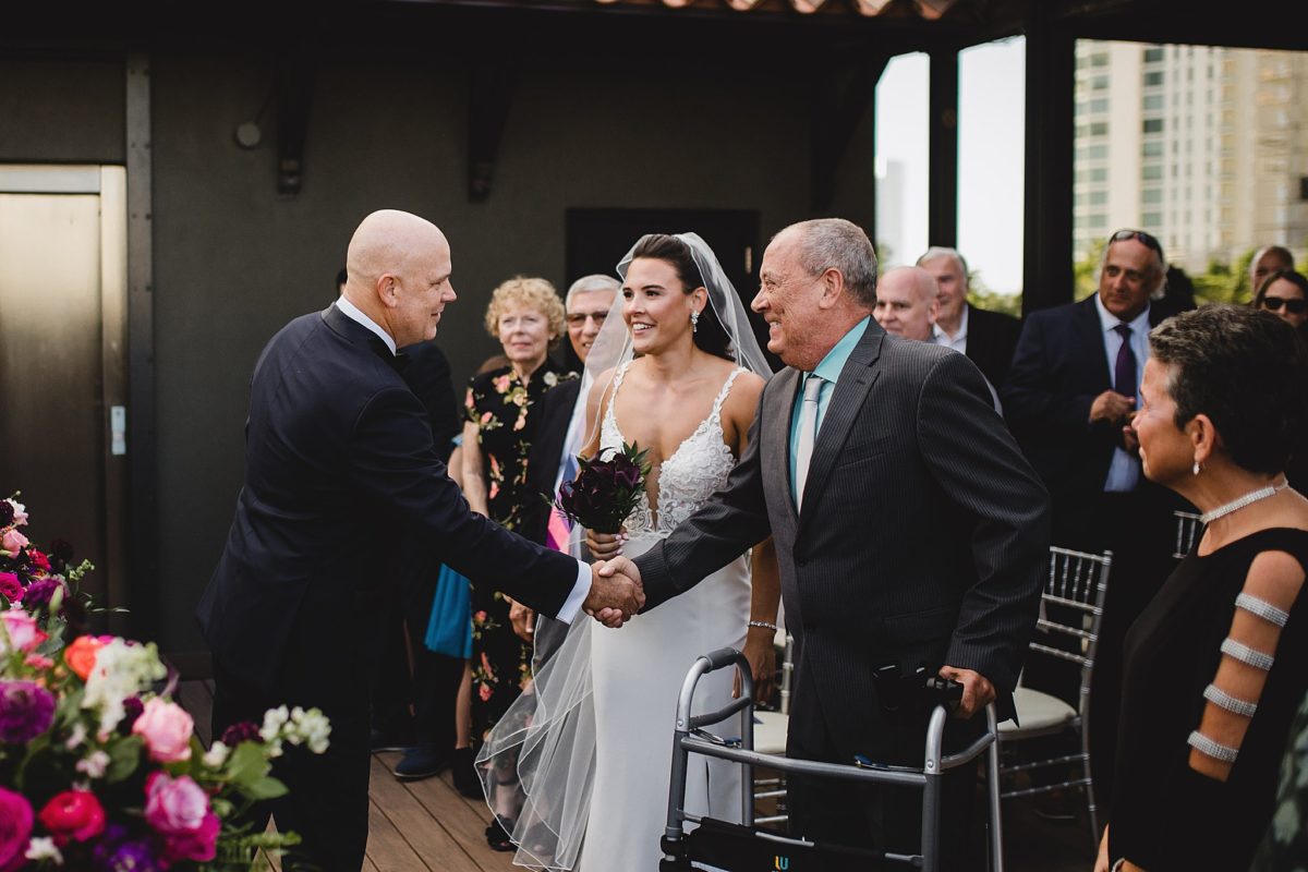father giving bride away at ceremony at sage restaurant in sarasota florida photographed by juliana montane photography