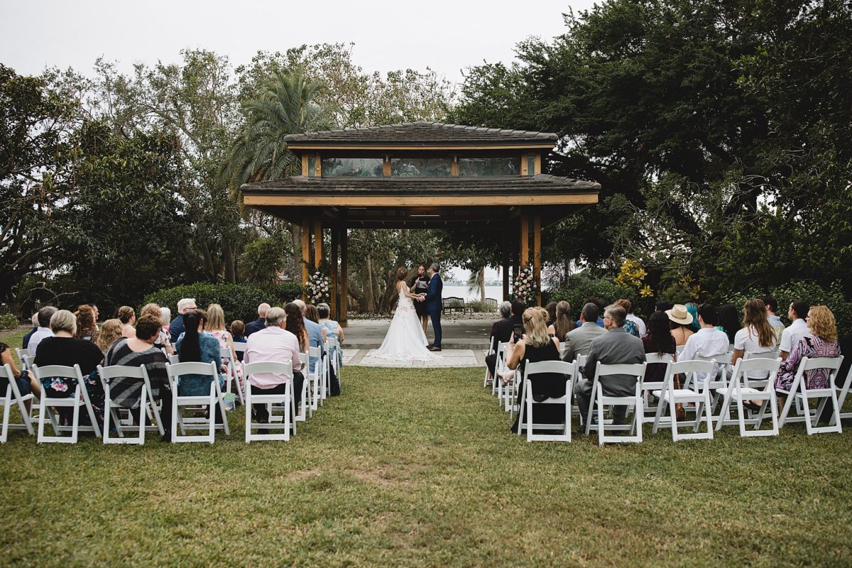 bride and groom getting married during wedding ceremony at marie selby botanical gardens