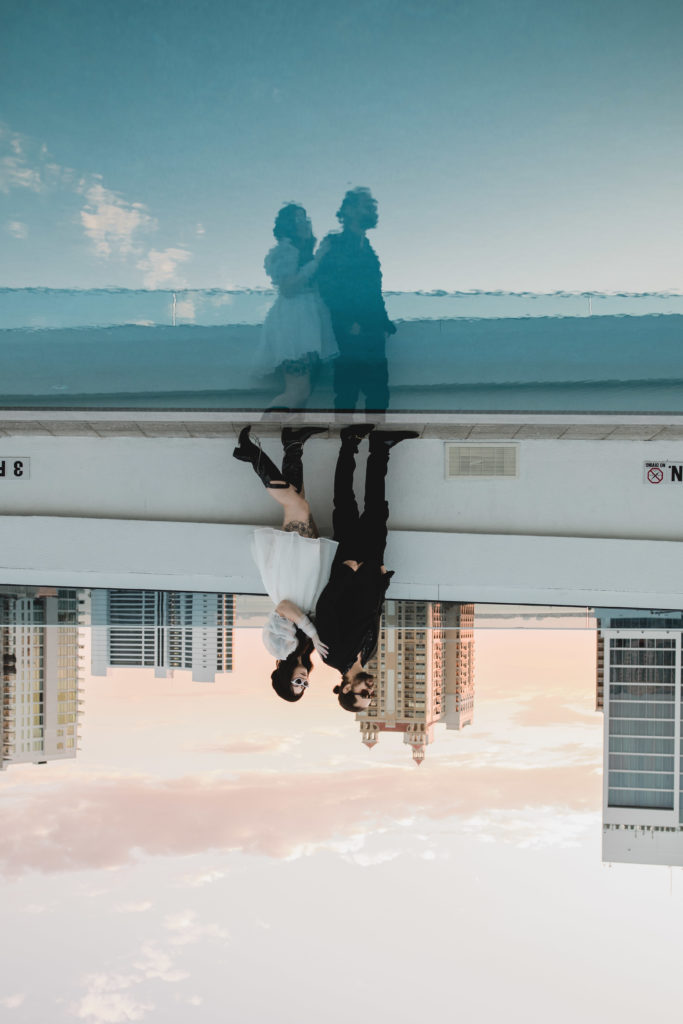 couple posing on the rooftop of art ovation hotel in downtown sarasota, photographed by juliana montane
