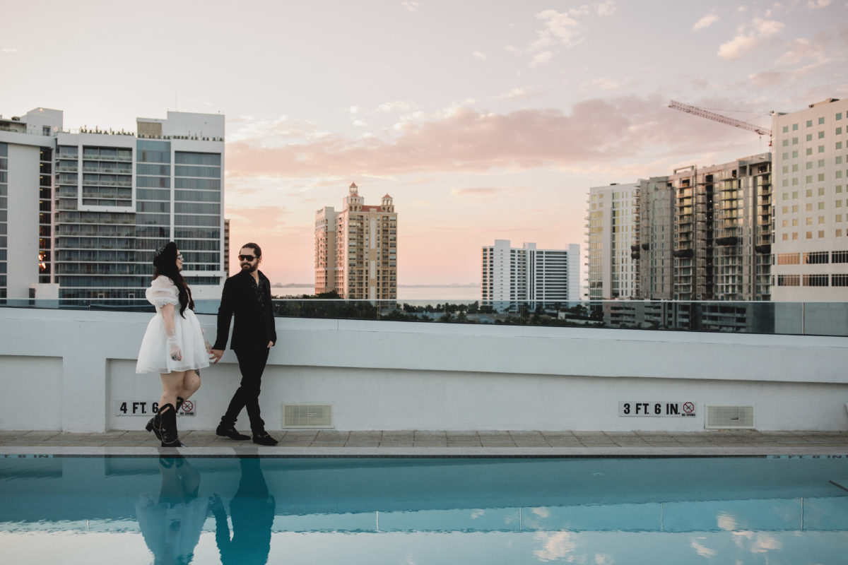 couple walking on the rooftop of art ovation hotel in downtown sarasota, photographed by juliana montane