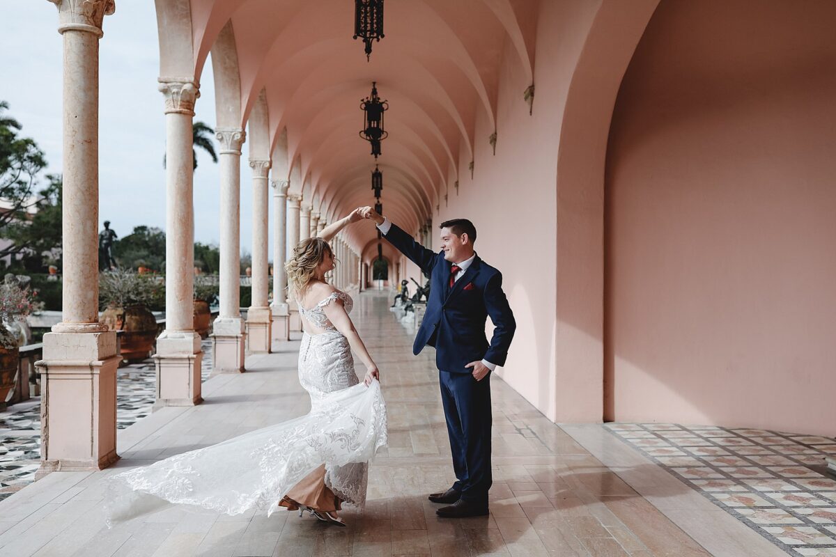 groom twirling bride in the courtyard at john ringling museum on wedding day in sarasota fl, wedding photography by juliana montane photography
