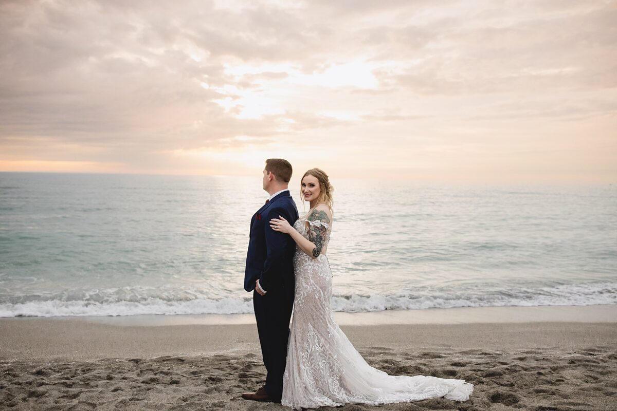 newly married couple watching the sunset at turtle beach in sarasota florida, wedding photography by juliana montane photography