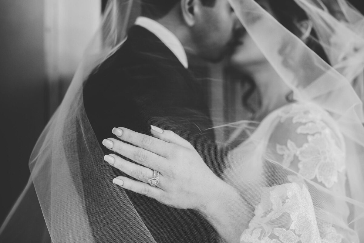 Close up photo of wedding ring underneath bride's veil photographed by Juliana Montane Photography