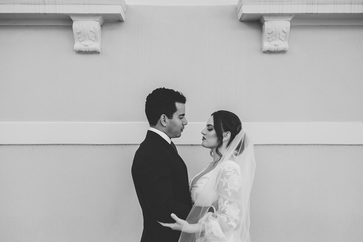 black and white photo of bride and groom outside of sarasota courthouse photographed by Juliana Montane Photography