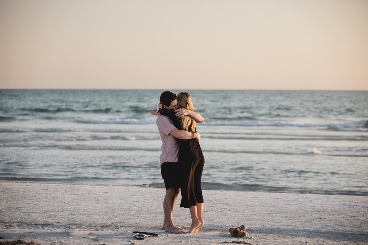 Man proposing to his girlfriend on siesta key beach in sarasota florida photographed by Juliana Montane Photography