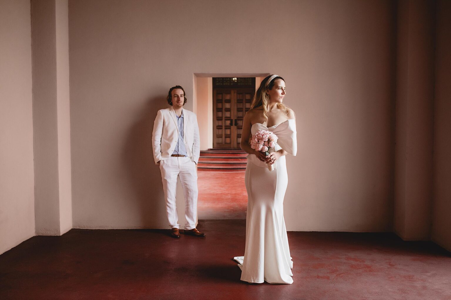 bride and groom posing in wedding dress and suit after eloping at the sarasota courthouse