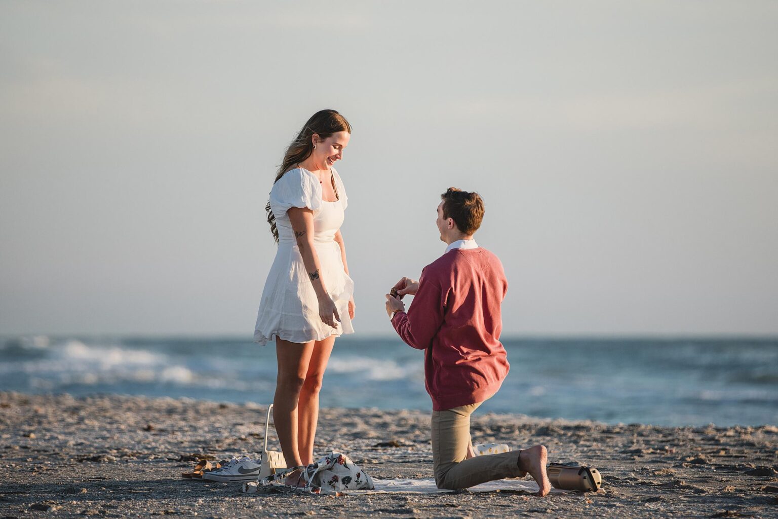 man proposing to his girlfriend on longboat key beach