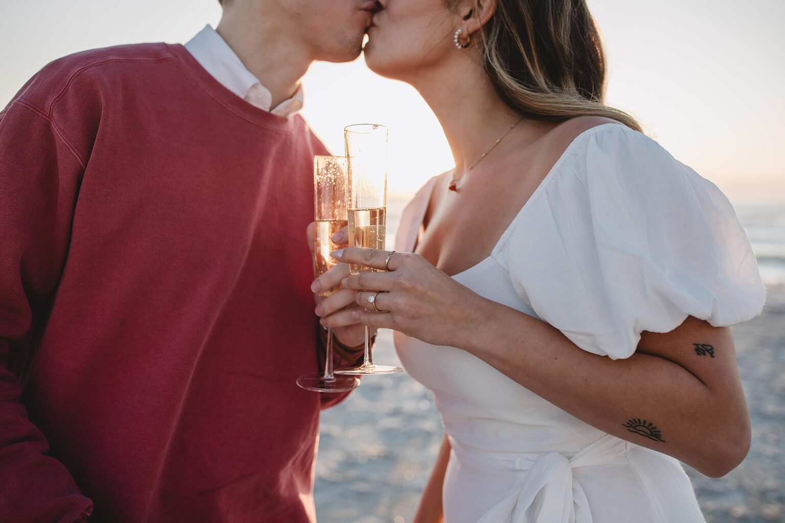 couple drinking champagne after their sarasota beach proposal