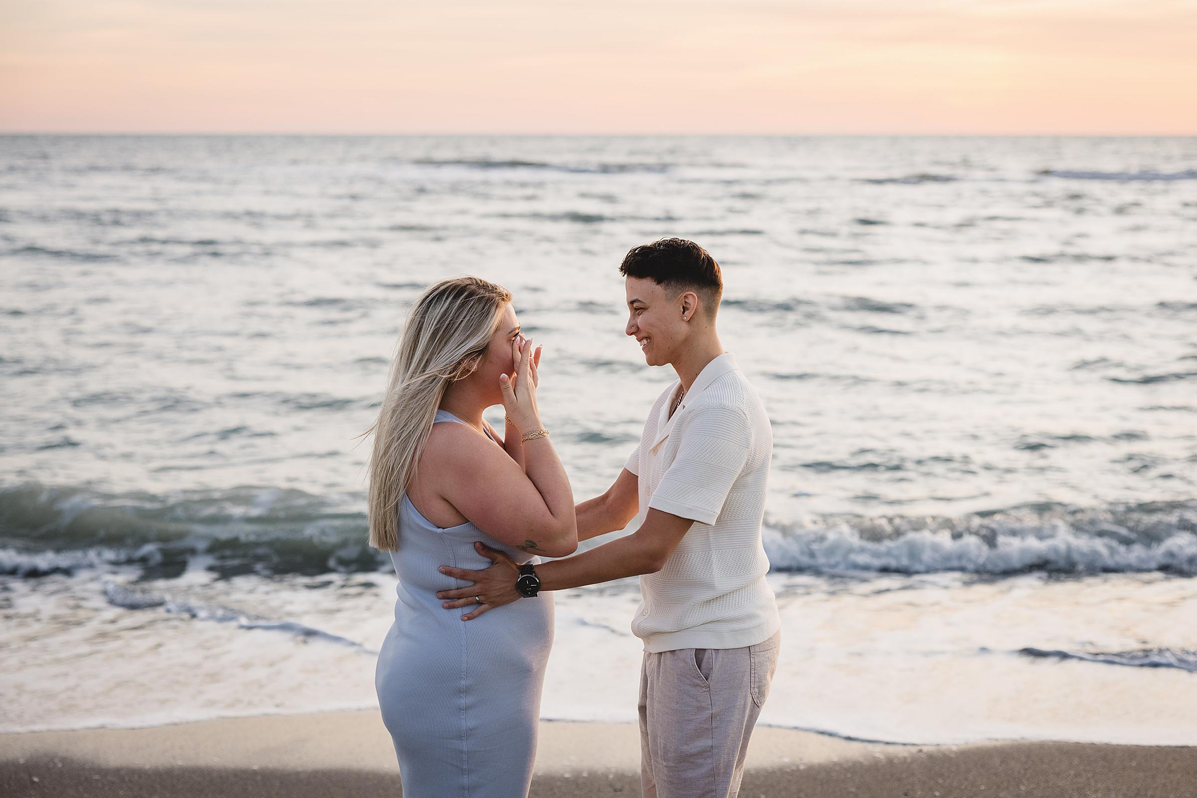 Woman crying after getting proposed to by her girlfriend on the beach in sarasota, florida. Photographed by Juliana Montane Photography