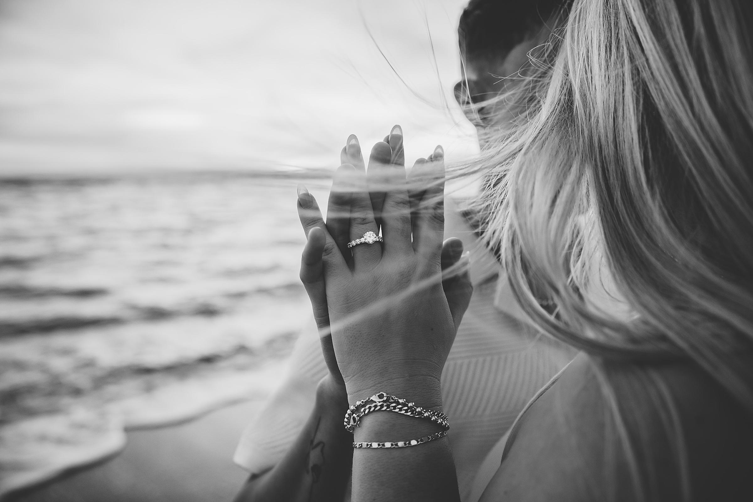 Close up of engagement ring on the beach in Venice, Florida. Photographed by Juliana Montane Photography