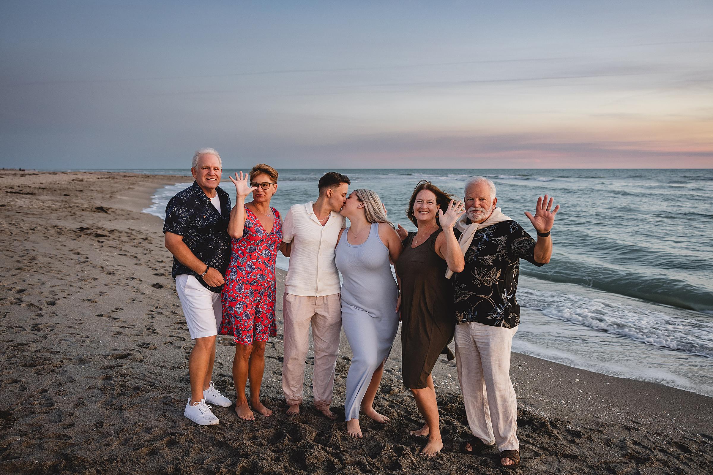 Parents celebrating their daughters engagement on the beach. Same sex couple surprise beach proposal in venice, florida. Photographed by Juliana Montane Photography