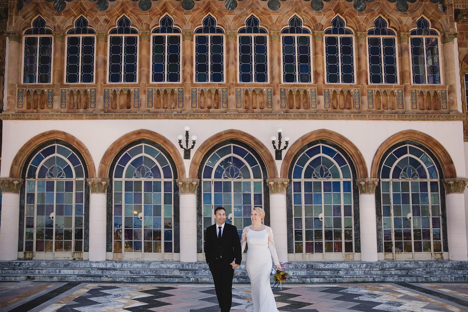 Couple posing in front of the Ca d'Zan at Ringling Museum after getting married in the Rose Garden. Photographed by Juliana Montane Photography.