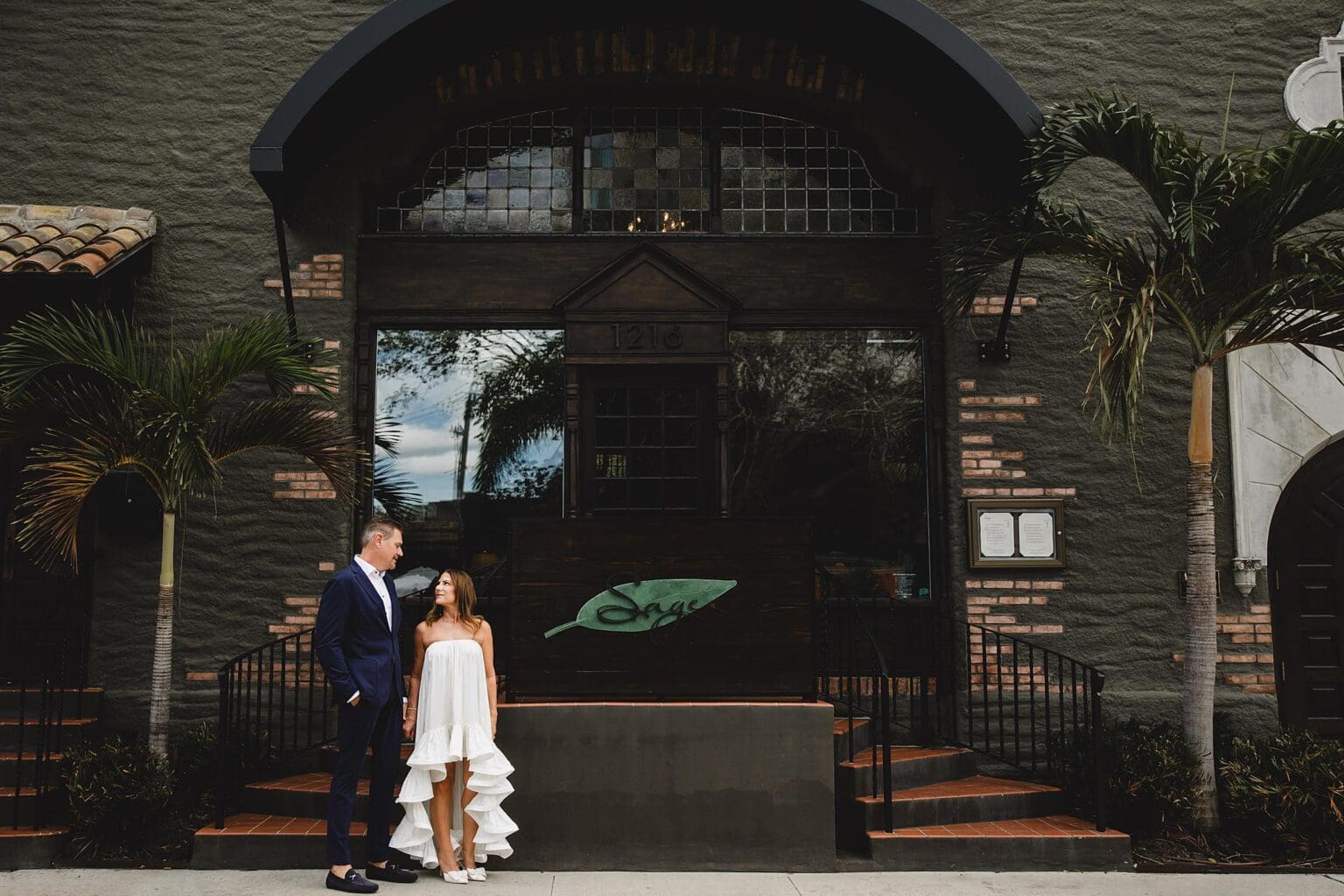 Bride & Groom posing outside of Sage Restaurant in downtown Sarasota, FL photographed by Juliana Montane Photography