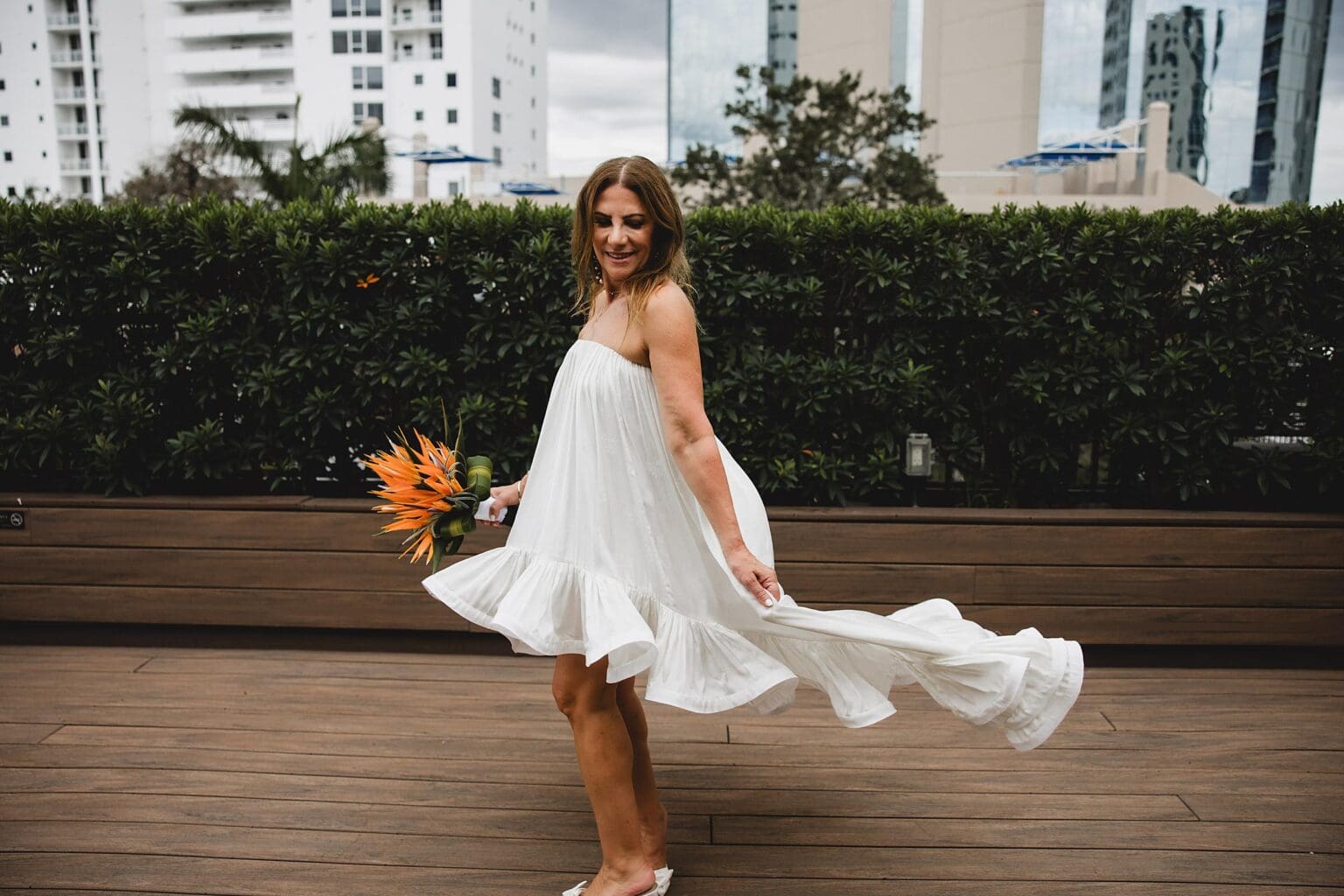 Bride twirling dress on the rooftop at Sage Restaurant in downtown Sarasota, FL photographed by Juliana Montane Photography