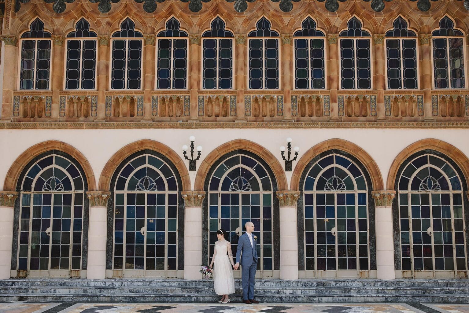 Bride & Groom posing at the back of the Ca d'Zan building at Ringling Museum in Sarasota Florida photographed by Juliana Montane Photography
