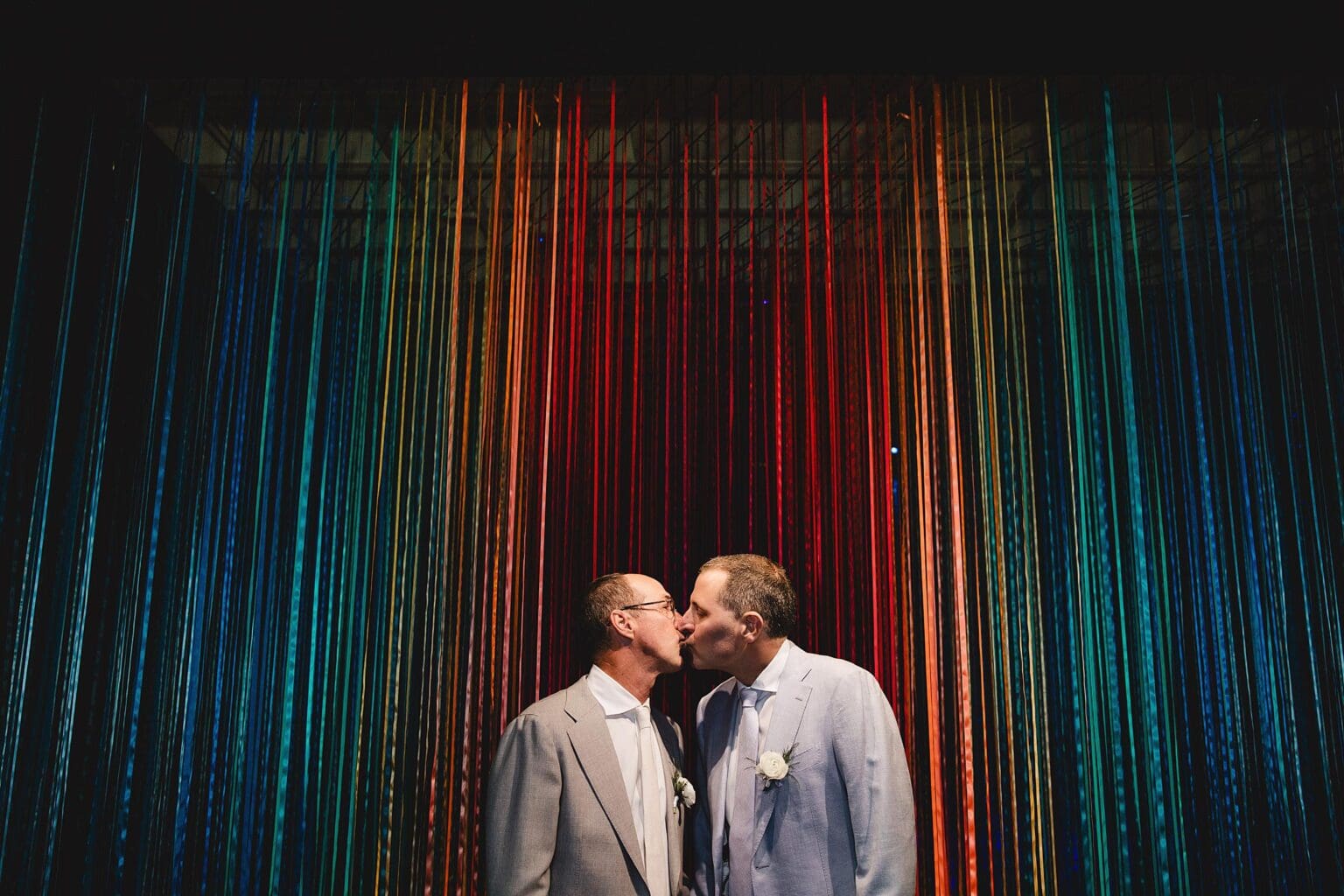 Grooms kissing at their Sarasota Art Museum wedding in Sarasota Florida photographed by Juliana Montane Photography