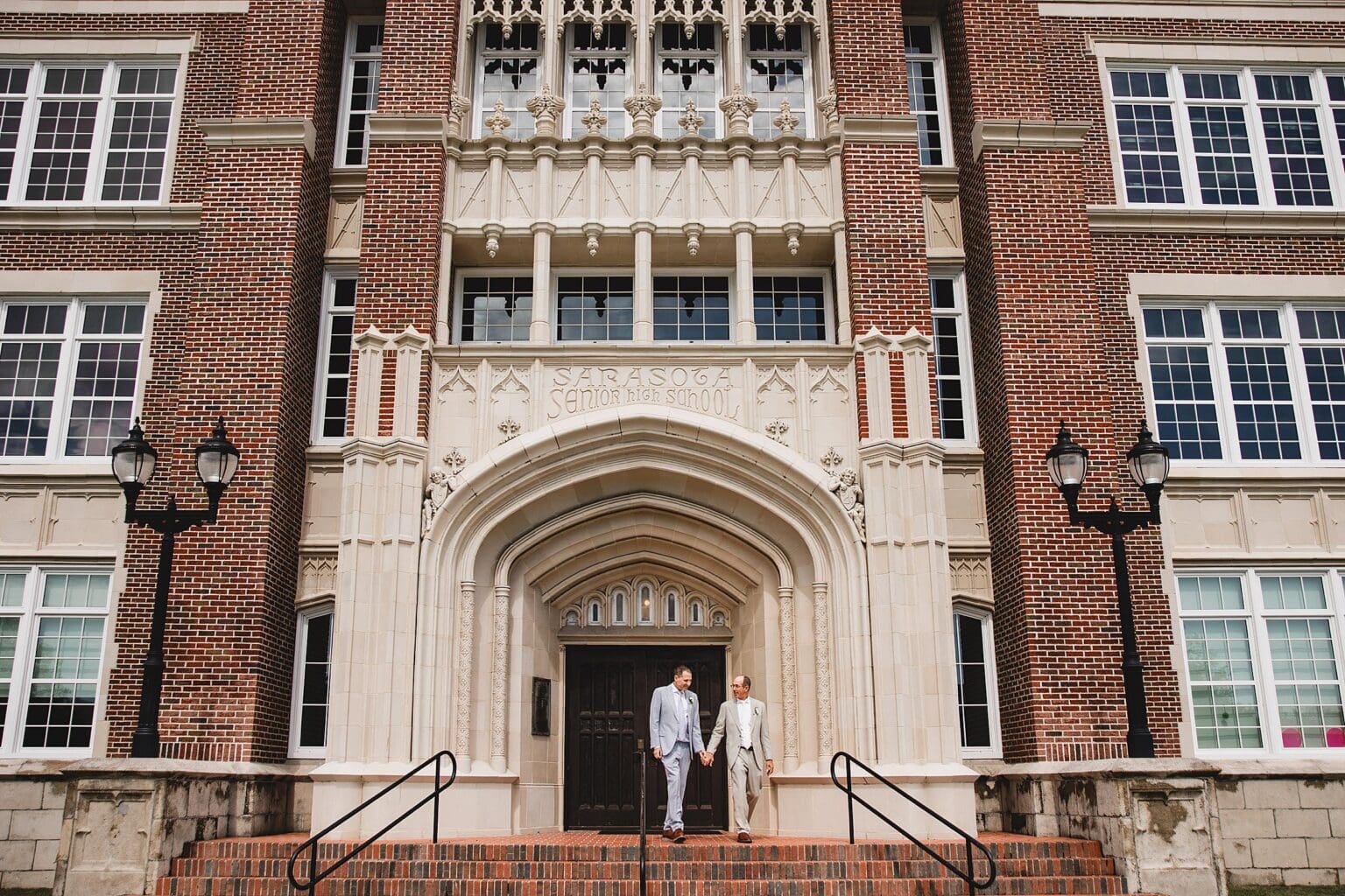 LGBTQ couple posing in front of the Sarasota Art Museum after their wedding in Sarasota photographed by Juliana Montane Photography