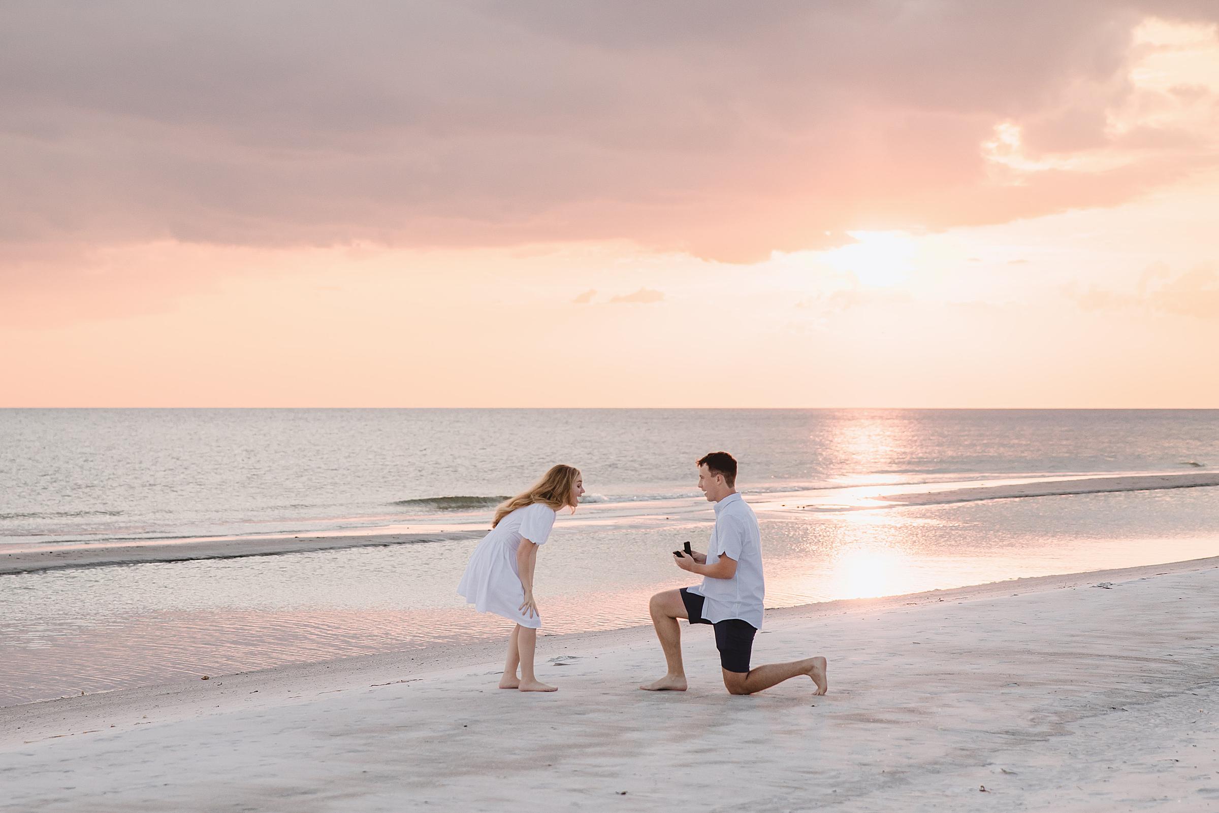 Man proposing on longboat key beach during sunset photographed by Juliana Montane Photography