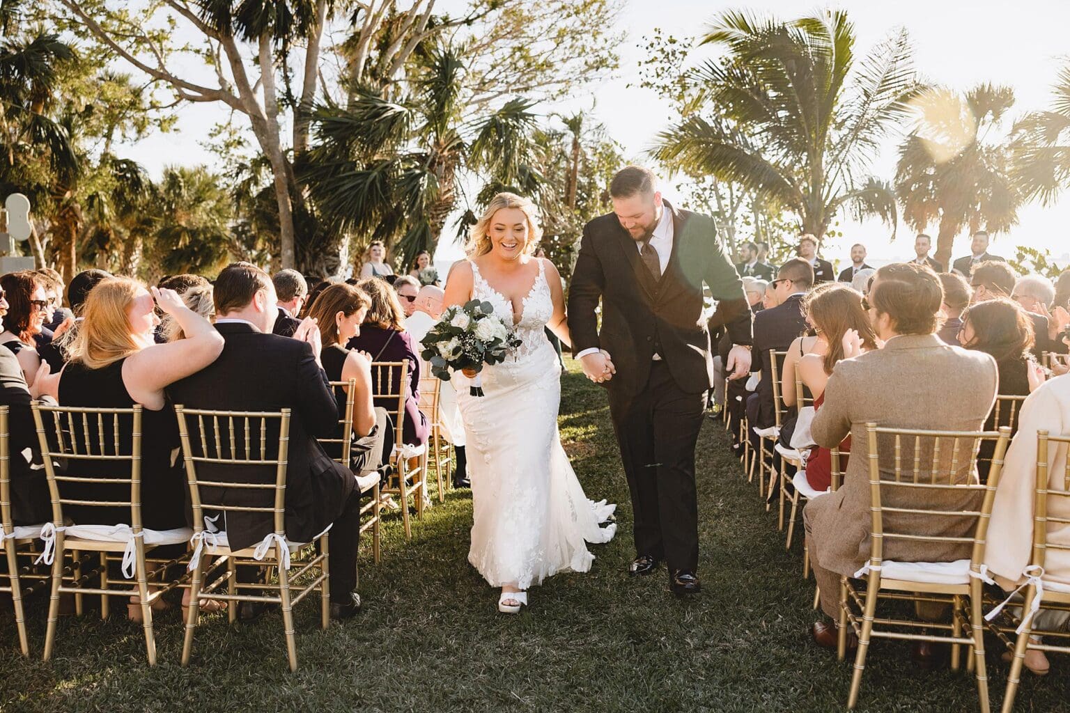 Bride & Groom walking down the aisle after their wedding ceremony at a Crosley Mansion wedding in Sarasota Florida photographed by Juliana Montane Photography