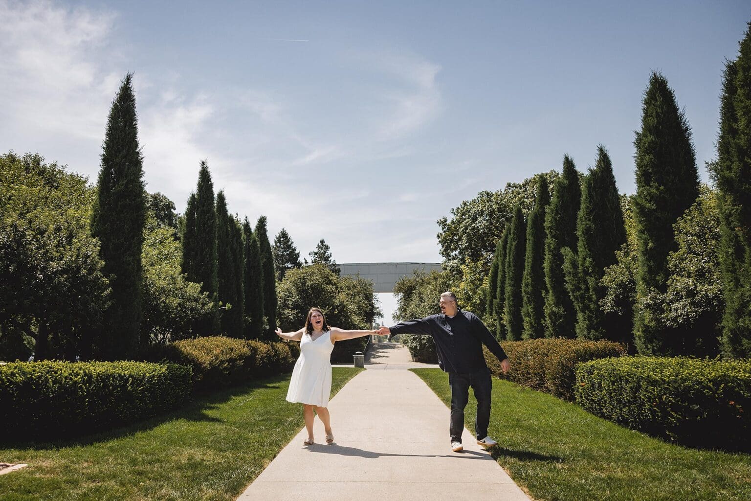 Engagement photos of couple laughing in Memorial Park in Omaha, NE during engagement session photographed by Juliana Montane Photography