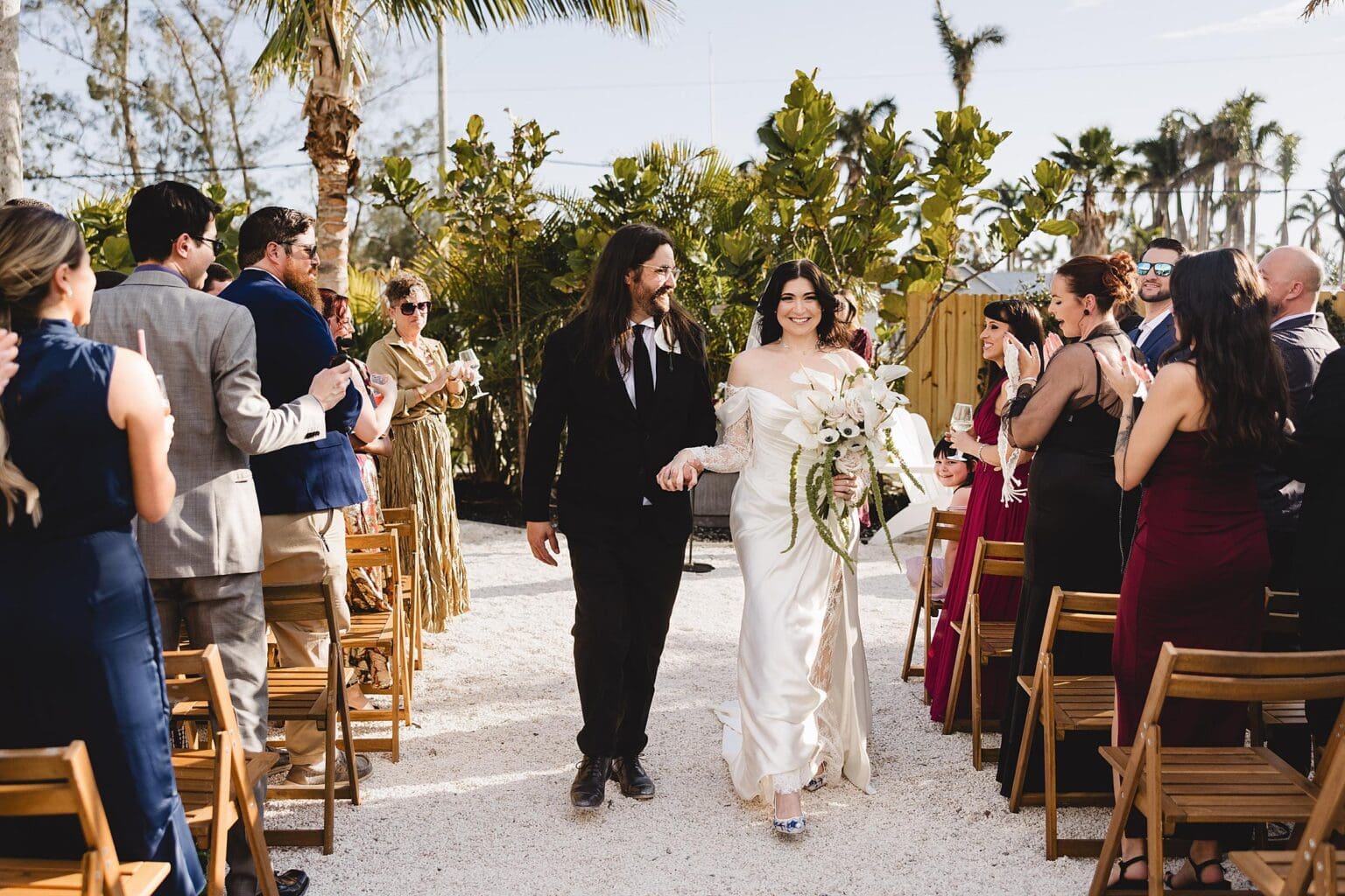Bride & Groom walking down the aisle after Wedding Ceremony at The Fox Mercantile in Bradenton Florida photographed by Juliana Montane Photography
